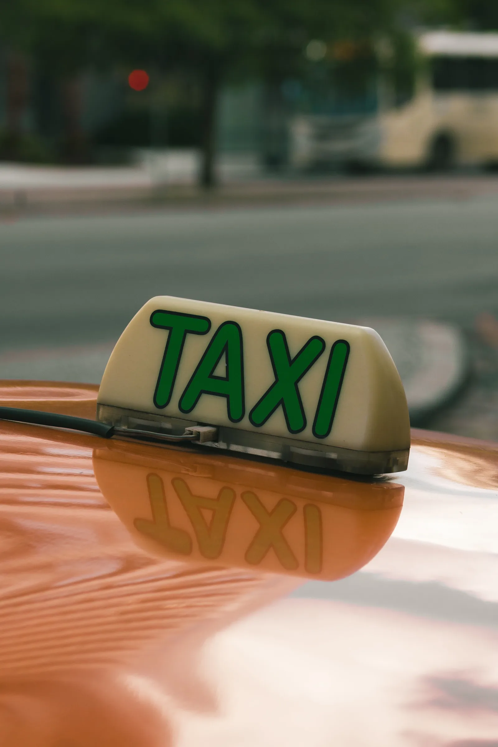 Close-up of an illuminated taxi sign on a car roof
